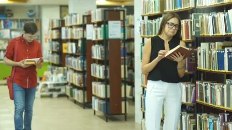 Two students met in the library and smiling Stock Footage 68571049