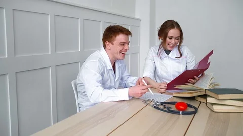 Two students of the physician preparing for the exam on the resident Stock Footage 128997342