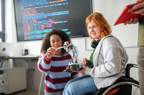 Two students showing classmates their science project. Stock Photos