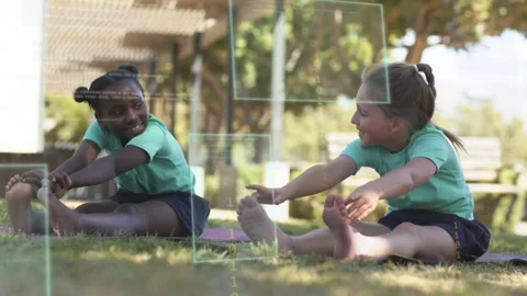 Two students sitting on mats starting synced forward stretch in education, HUD Stock Footage 333936477