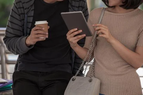 Two students studying with computer notebook outdoors Stock Photos