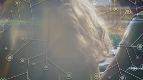 Two students typing keys starting net overlay on screens camera pulling back Stock Footage 333602480