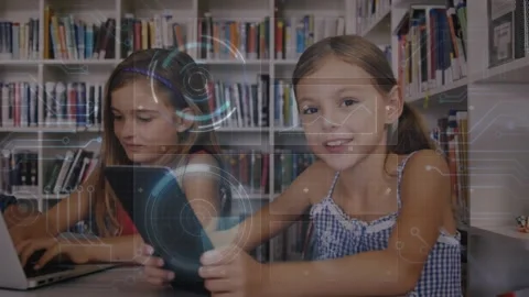 Two students typing on laptop and tapping tablet in library, tablet tap Stock Footage 332281185