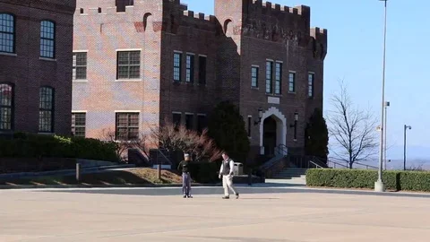 Two Students Walking Across McLendon Quadrangle in Foreground of Elkin Hall Stock Footage 69231925