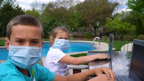 Two students wearing masks while virtual learning Stock Footage 128133036