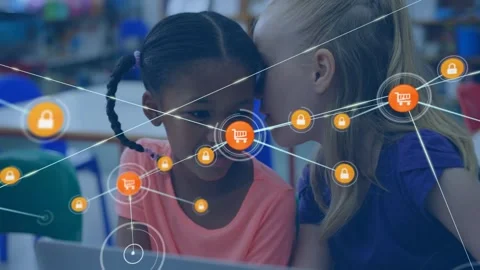 Two students whispering at laptop, starting cart and lock node overlay and Video stock 330191296