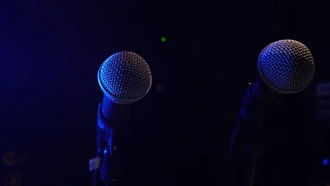Two Studio condenser microphone, on background of neon pattern in blue. Stock Footage 265856391