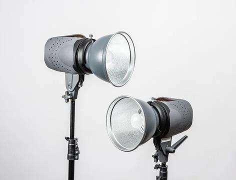Two studio strobe lights on light stands. Stock Photos