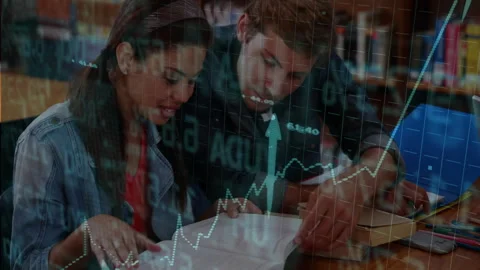 Two study partners pointing at book and comparing market data on phone with Stock Footage 312280704