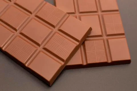Two stylish chocolates on a dark background Fotos de archivo
