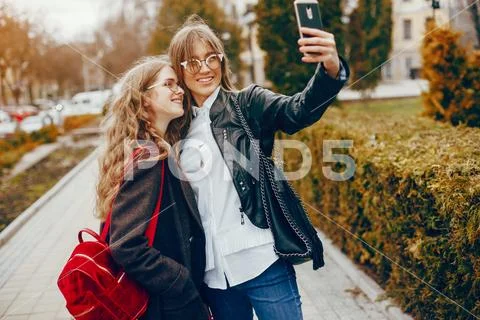 Two stylish girl in a city Stock Photos