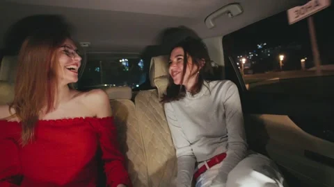 Two stylish girlfriends are having a fantastic time enjoying a vibrant night out Stock Footage 298263330