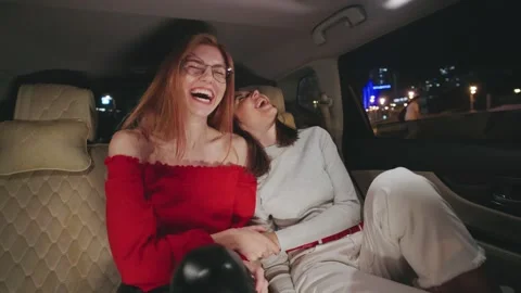 Two stylish girlfriends are having a fantastic time enjoying a vibrant night out Stock-Footage 298295583