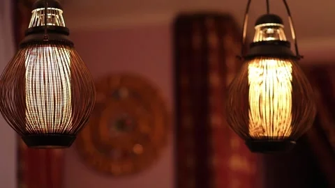 Two stylish lamps hang from ceiling in room with asian decoration, variable Video stock 276365073