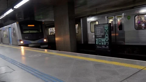 Two subway trains stopped at different tracks inside an underground station Stockbeeldmateriaal 338185693