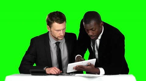 Two successful businessman sit down at the negotiating table in the office and Stock Footage 62816361
