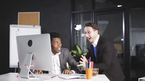 Two Successful businessmans juming and raising hands in the office Stock Footage 80990645