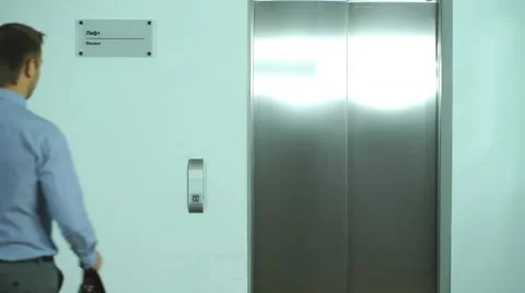 Two successful businessmen meet in the Elevator Stock Footage 67495109