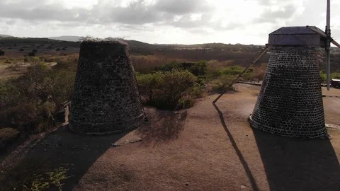 Two sugar cane wind mills restored in Antigua aerial drone 4k windmill Stock Footage 111311832