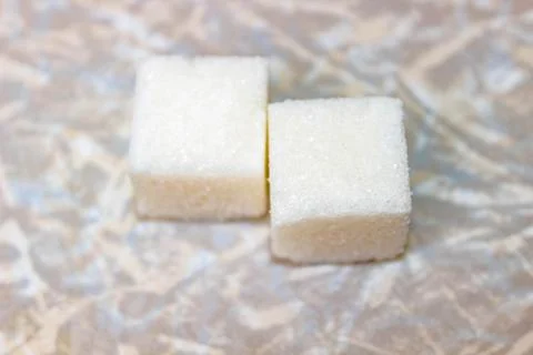 Two sugar cubes on the kitchen light table. Foto stock