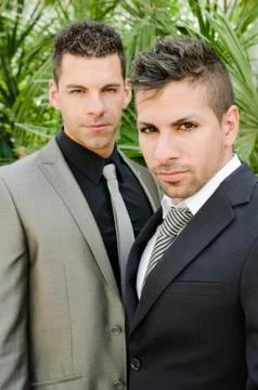 Two suit young men posing looking at the view Stock Photos
