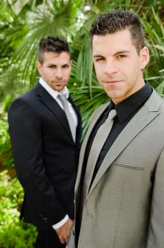 Two suit young men posing looking at the view Stock Photos