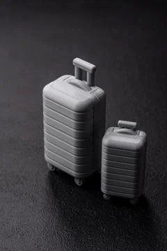 Two suitcases on a black background representing the concept of travel, emi.. Stock Photos