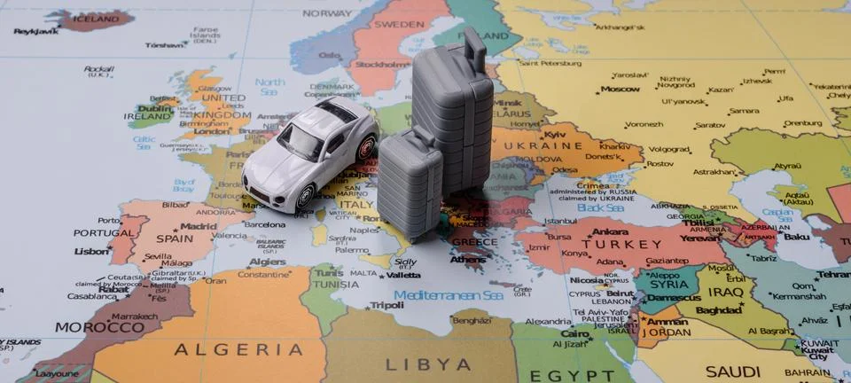 Two suitcases on a map representing the concept of travel, emigration, or a.. Stock Photos