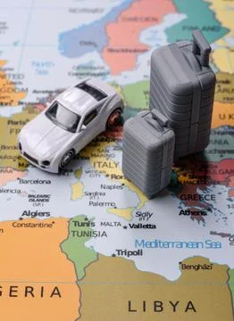 Two suitcases on a map representing the concept of travel, emigration, or a.. Stock Photos