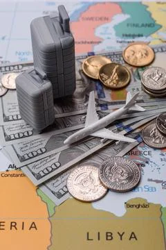 Two suitcases on a map representing the concept of travel, emigration, or a.. Stock Photos