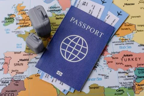 Two suitcases on a map representing the concept of travel, emigration, or a.. Stock Photos