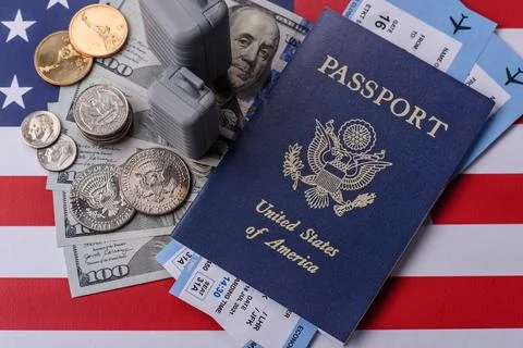 Two suitcases on a USA flag representing the concept of travel, emigration, o Stock Photos