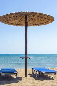 Two sun beds under sun umbrella at the beach. Zephyros beach. Greece Stock-Fotos