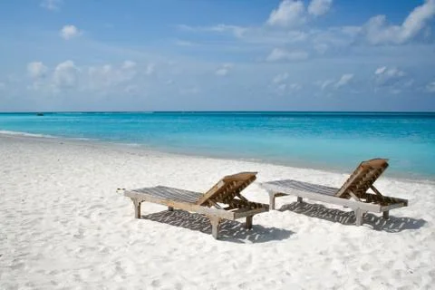 Two sunbeds on the beach Stock Photos