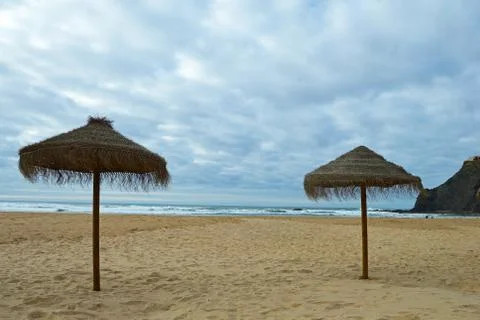 Two sunshade on the beach in Odeceixe on the Atlantic coast of Portugal Stock Photos