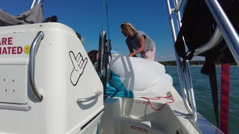 Two Surfer Dude Guys Putting Parasail Away Vídeo Stock 249955075