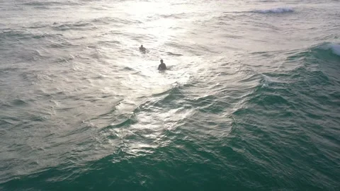 Two surfer guys at sunset Stock Footage 198683294