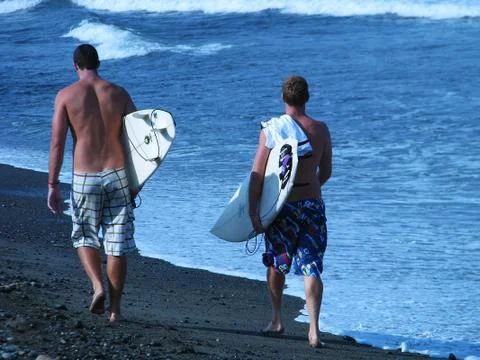 Two surfers on the beach Stock Photos