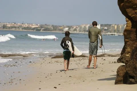 Two Surfers On The Beach Stock Photos