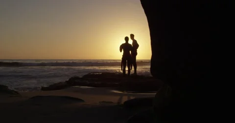Two Surfers Enjoying the Sunset Stock Footage 68551420