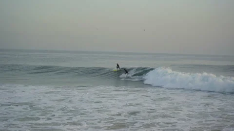 Two surfers fighting over a wave in taghazout anchor point spot Stock Footage 296660441