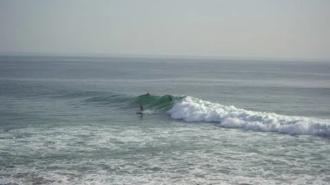 Two surfers fighting over a wave in taghazout anchor point spot Stock Footage 296687081