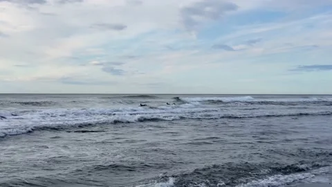 Two surfers glide on the waves of the Pacific Ocean Video stock 141246978