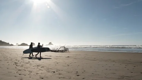 Two Surfers Head Out To Surf Oregon Coast Video stock 120213182