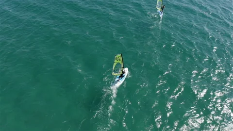 Two surfers ride the waves of a clear sea Video stock 144799396
