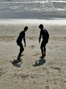 Two surfers on the sandy beach Stock Photos