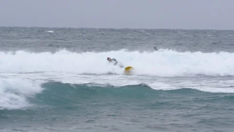 Two surfers try to catch a wave in the Pacific ocean 004 Stock Footage 124776819