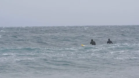 Two surfers try to catch a wave in the Pacific ocean 009 Stock Footage 124780070