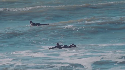 Two surfers waiting the wave in ocean Stock Footage 98700039