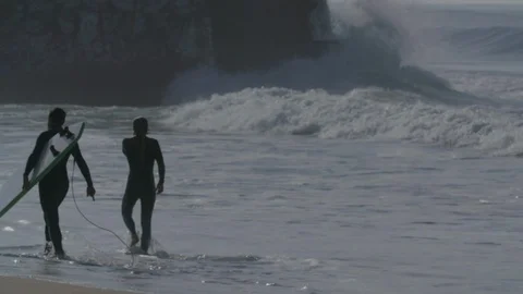 Two surfers walking on the beach - Slow motion Stock Footage 105313426